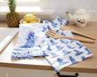 Blue Pineapple Kitchen Towel, 18x25 inch, folded and stacked with the all-over pineapple towel