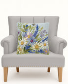 Blue Wildflowers Hooked Wool Throw Pillow on an armchair, showing the throw pillow at room scale, 18x18 inch