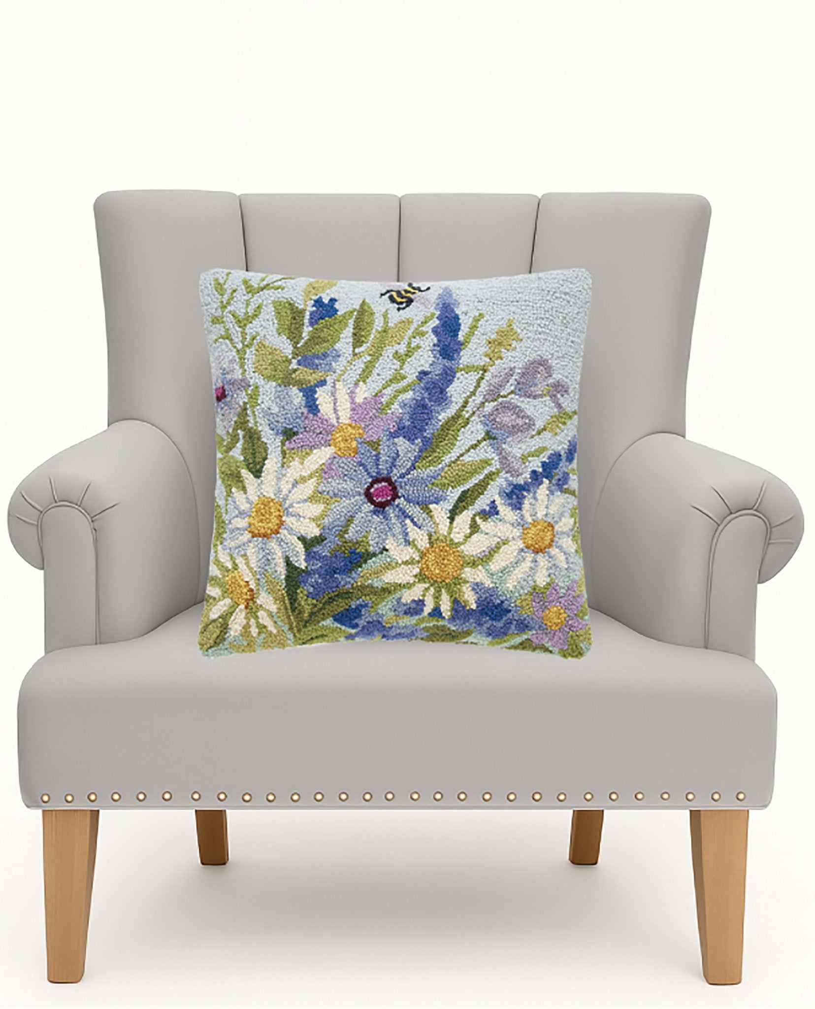 Blue Wildflowers Hooked Wool Throw Pillow on an armchair, showing the throw pillow at room scale, 18x18 inch