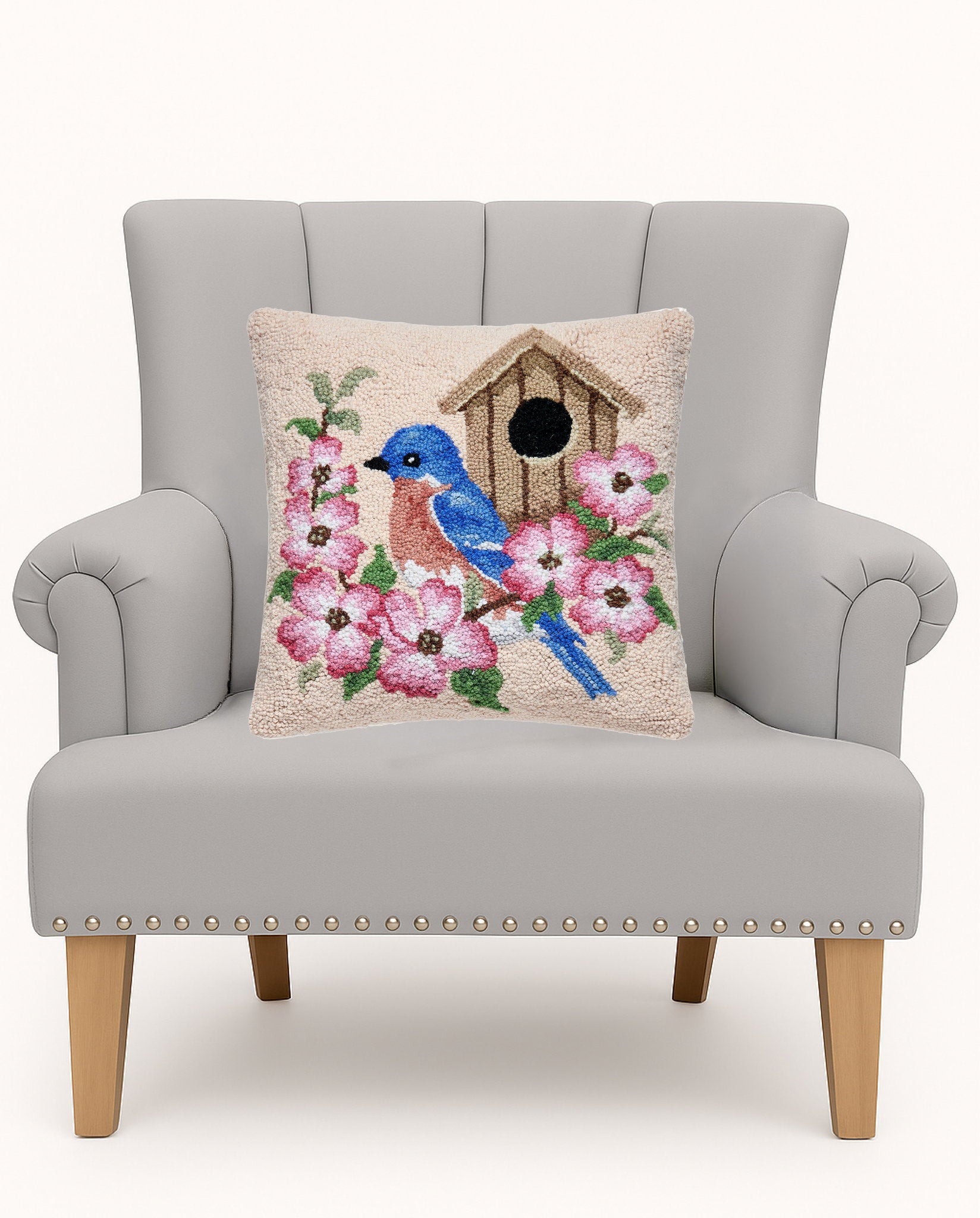 Bluebird Birdhouse Hooked Wool Throw Pillow on an armchair, showing the throw pillow at room scale, 16x16 inch