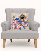 Bluebird Birdhouse Hooked Wool Throw Pillow on an armchair, showing the throw pillow at room scale, 16x16 inch