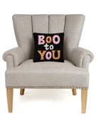 Boo to You Hooked Wool Halloween Throw Pillow on an armchair, showing the throw pillow at room scale, 10x10 inch