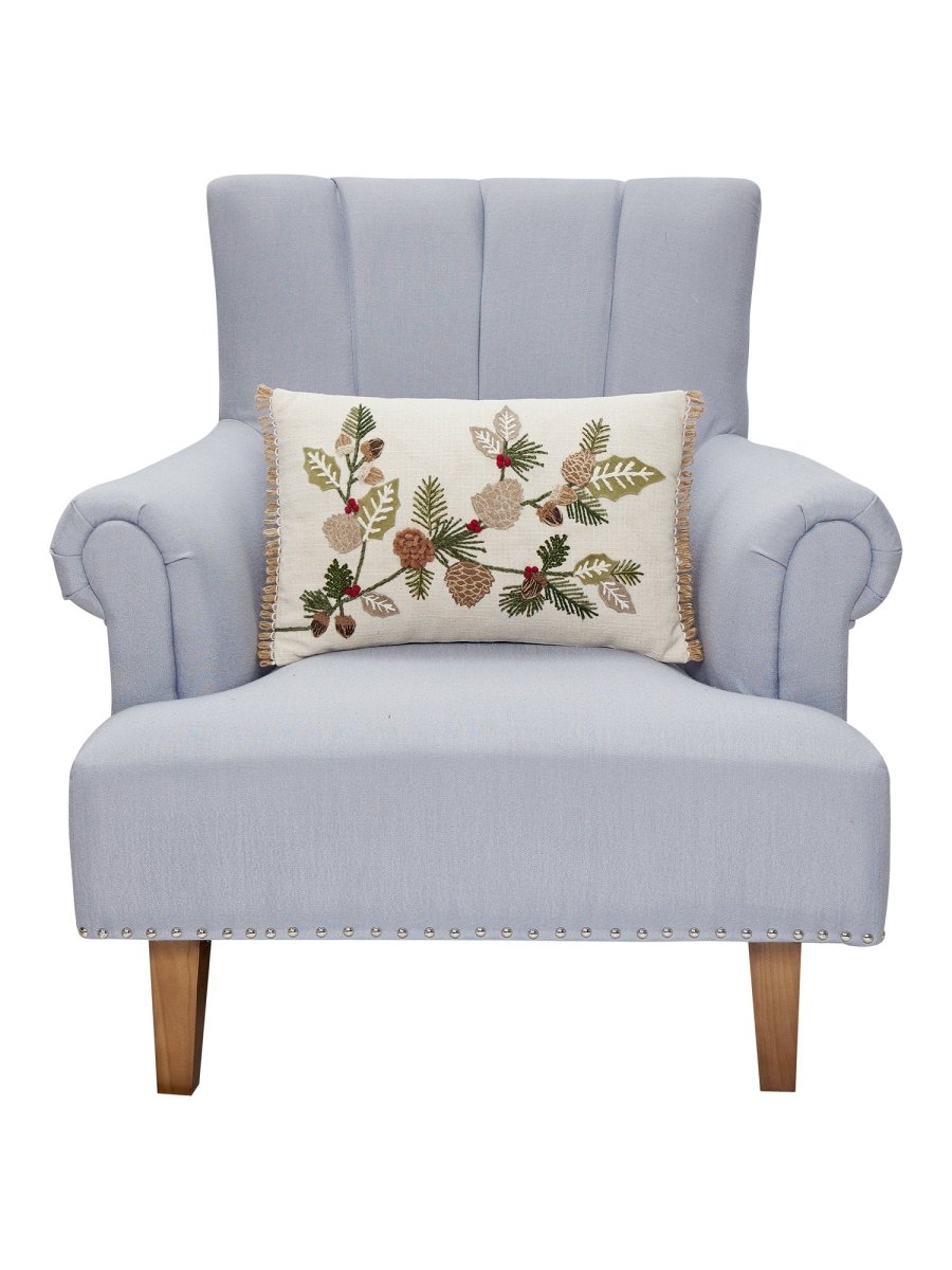Branches Embroidered Christmas Throw Pillow on an armchair, showing the throw pillow at room scale, 12x18 inch