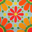 Bright 60s Boho Peace Love Embroidered pillow fabric closeup showing hand-embroidered needlepoint wool texture and color detail