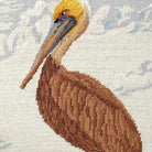 Brown Pelican Coastal pillow fabric closeup showing hand-embroidered needlepoint wool texture and color detail