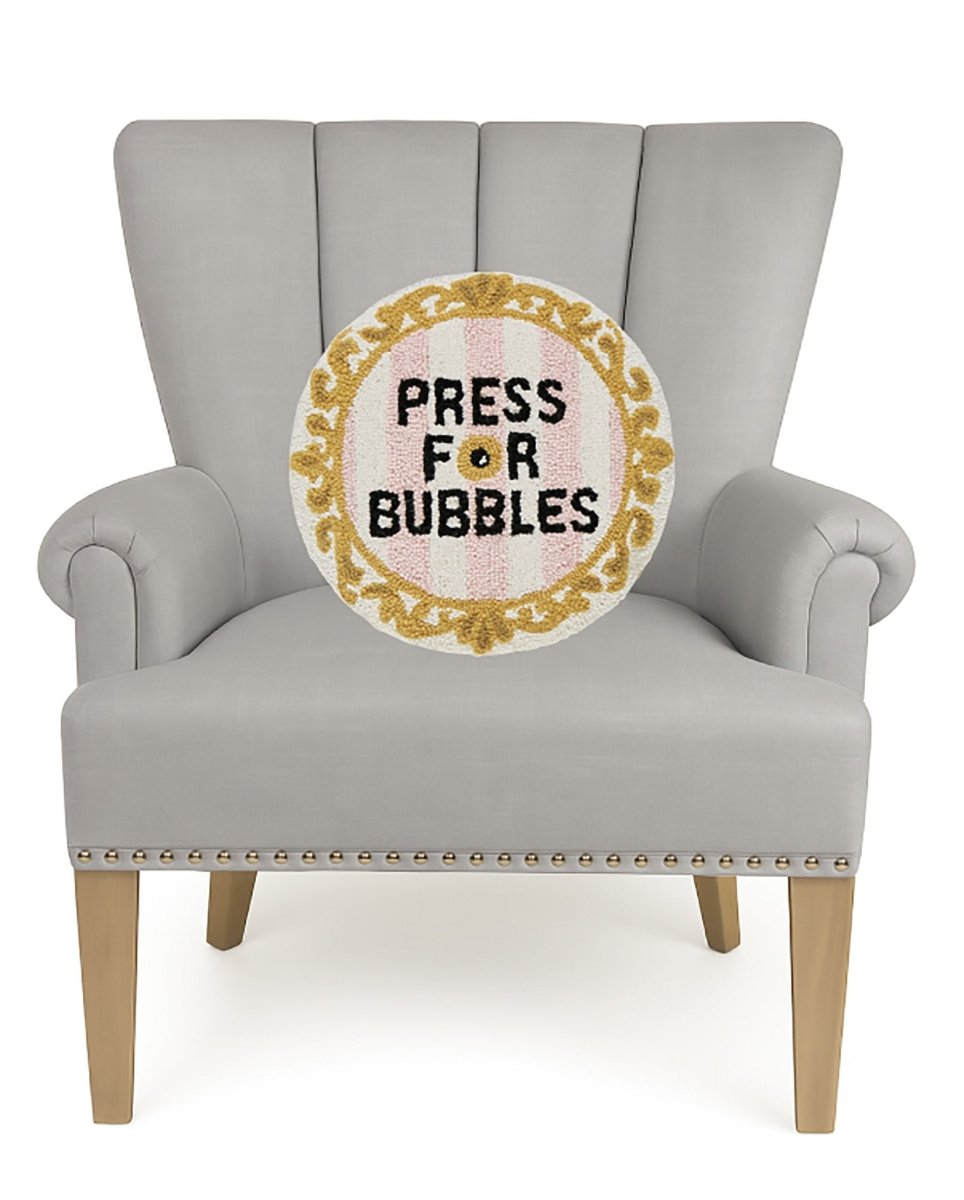 Bubbles Bell Hooked Wool Throw Pillow on an armchair, showing the throw pillow at room scale, 16x16 inch