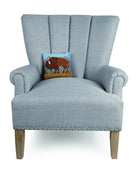 Buffalo Hooked Wool Throw Pillow on an armchair, showing the throw pillow at room scale, 8x8 inch