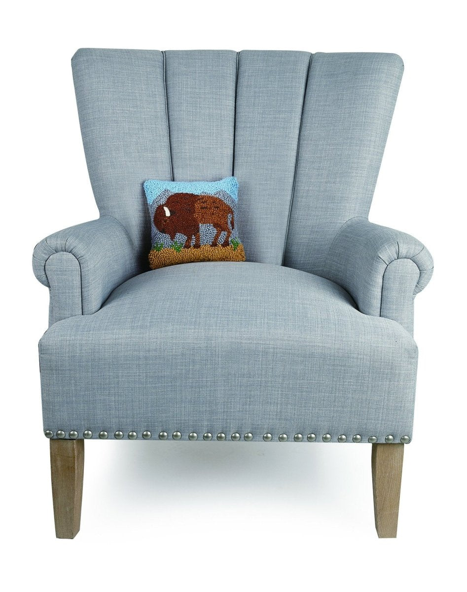 Buffalo Hooked Wool Throw Pillow on an armchair, showing the throw pillow at room scale, 8x8 inch