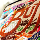 Buffalo, NY Waterfront City Embroidered Travel Pillow - close-up detail of hand-embroidered needlepoint stitching