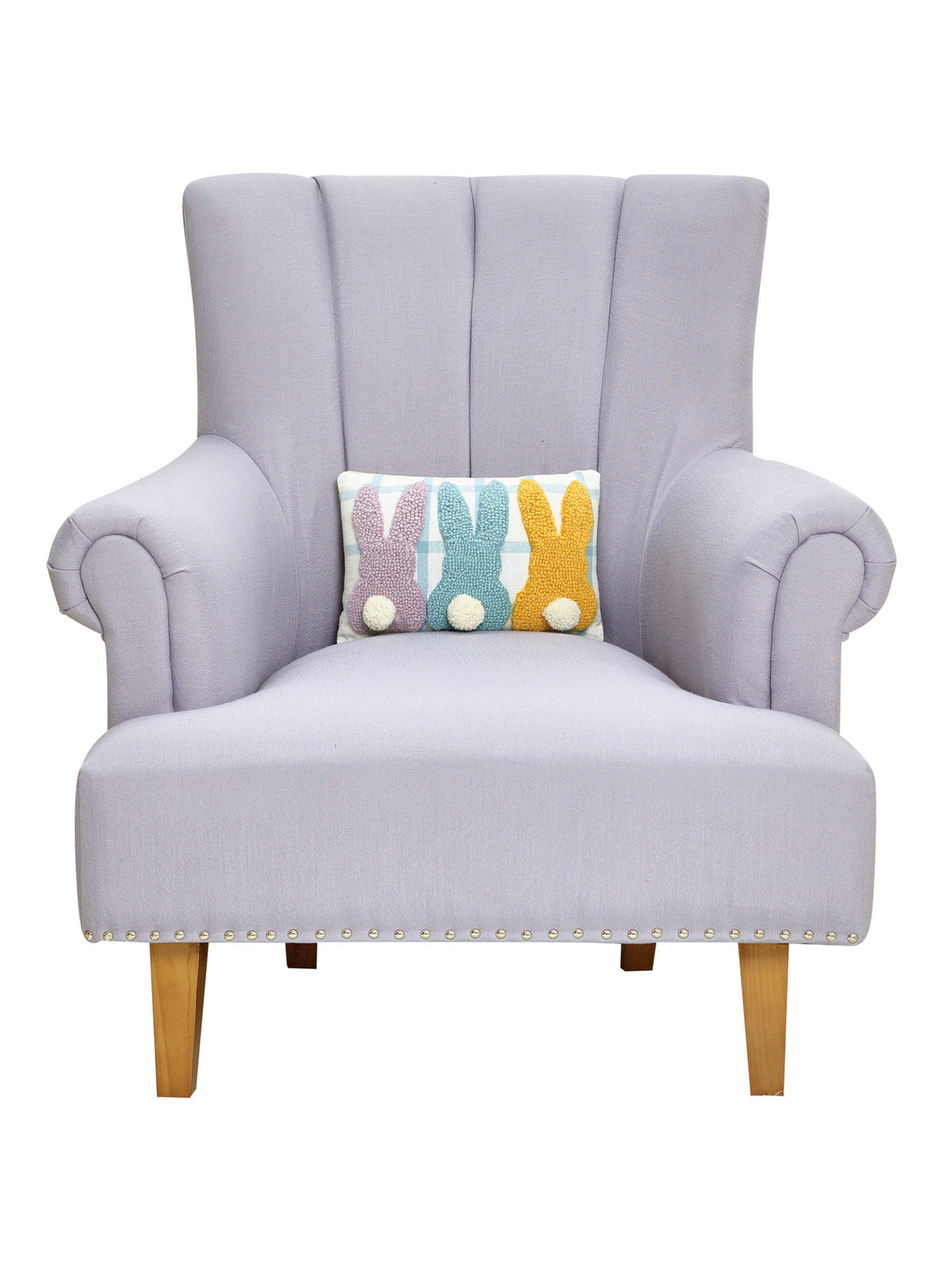 Bunny Pom Poms Tails Hooked Wool Easter Throw Pillow on an armchair, showing the throw pillow at room scale, 8x12 inch