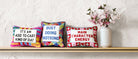 Busy Doing Nothing Embroidered Needlepoint Throw Pillow shown alongside other designs in the same collection, 12x12 inch