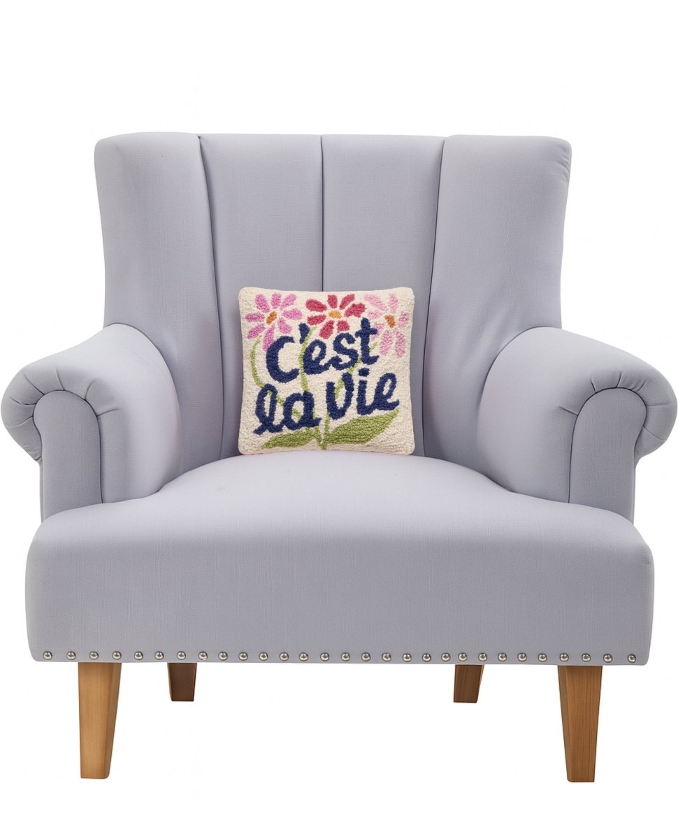 C'est La Vie Hooked Wool Throw Pillow on an armchair, showing the throw pillow at room scale, 10x10 inch