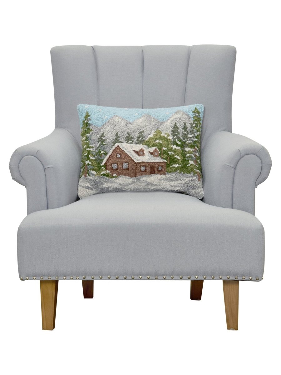 Cabin Hooked Wool Christmas Throw Pillow on an armchair, showing the throw pillow at room scale, 14x18 inch