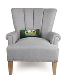 Camper Hooked Wool Throw Pillow on an armchair, showing the throw pillow at room scale, 12x5 inch