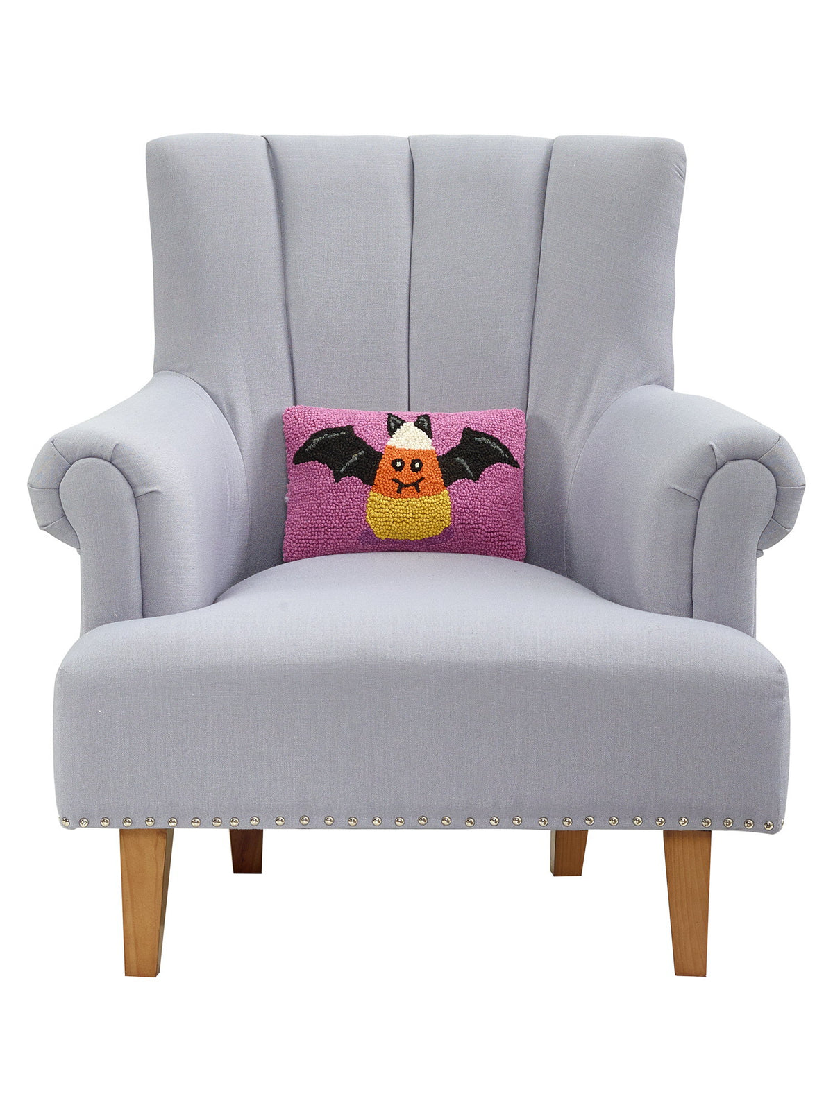 Candy Bat Hooked Wool Halloween Throw Pillow on an armchair, showing the throw pillow at room scale, 8x12 inch