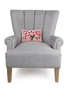Candy Cane Joy Hooked Wool Christmas Throw Pillow on an armchair, showing the throw pillow at room scale, 8x12 inch