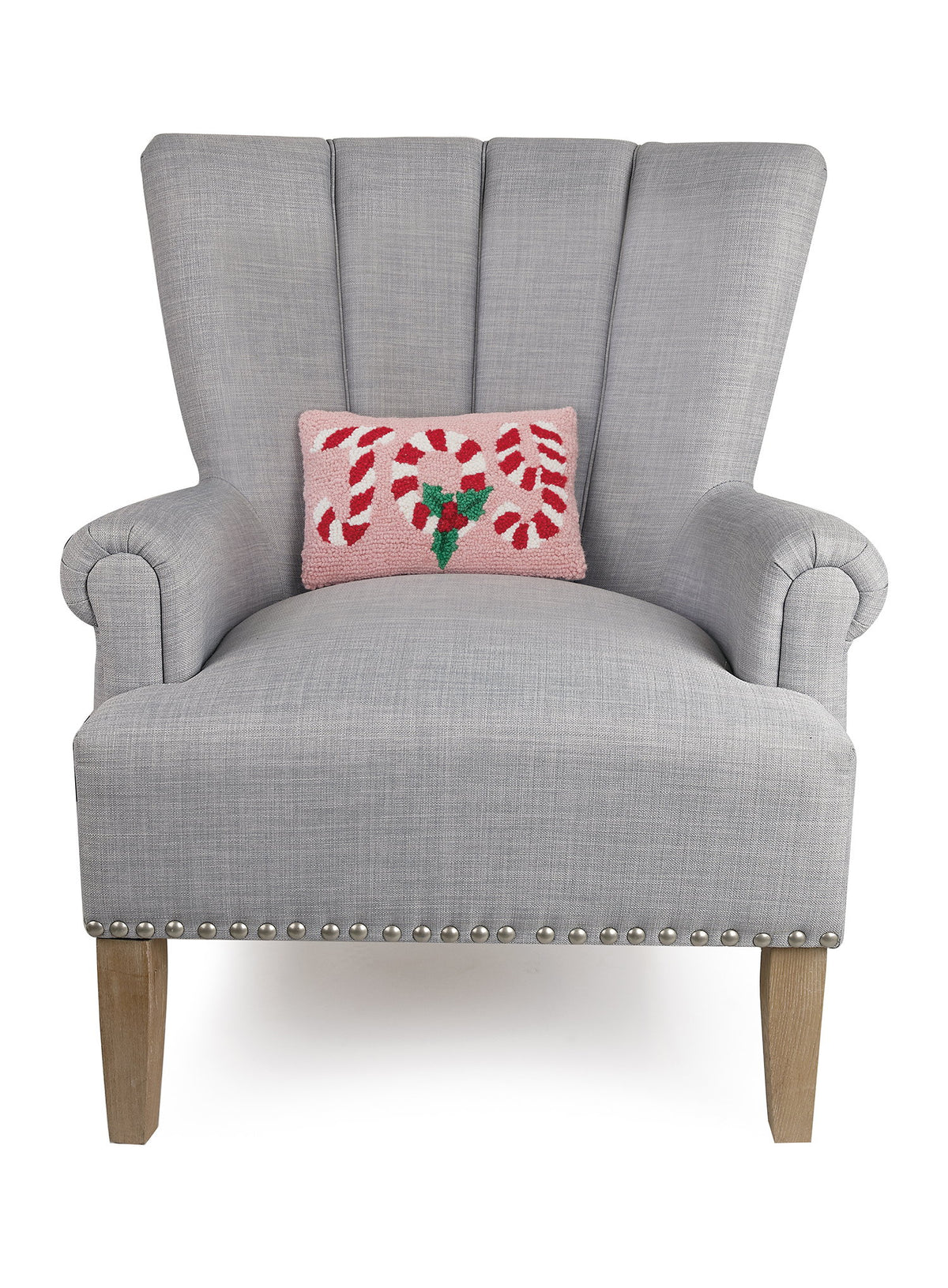 Candy Cane Joy Hooked Wool Christmas Throw Pillow on an armchair, showing the throw pillow at room scale, 8x12 inch