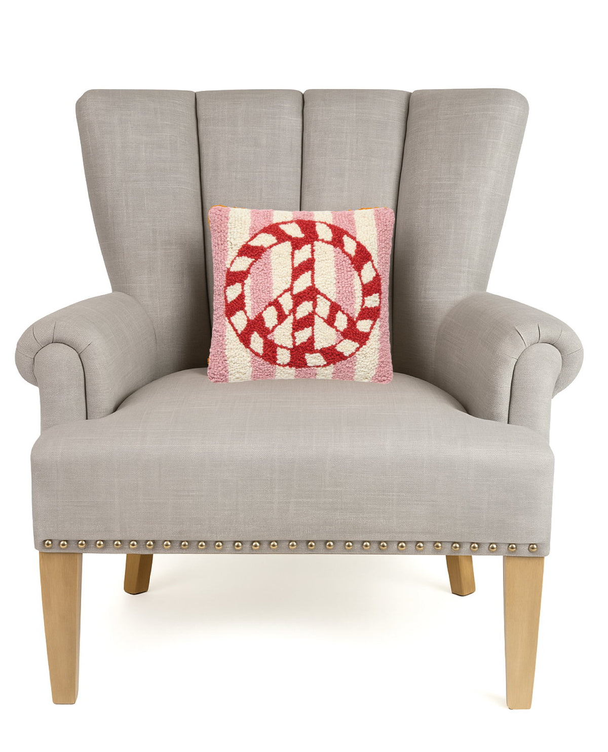 Candy Cane Peace Stripe Hooked Wool Christmas Throw Pillow on an armchair, showing the throw pillow at room scale, 10x10 inch