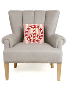Candy Cane Peace Stripe Hooked Wool Christmas Throw Pillow on an armchair, showing the throw pillow at room scale, 10x10 inch