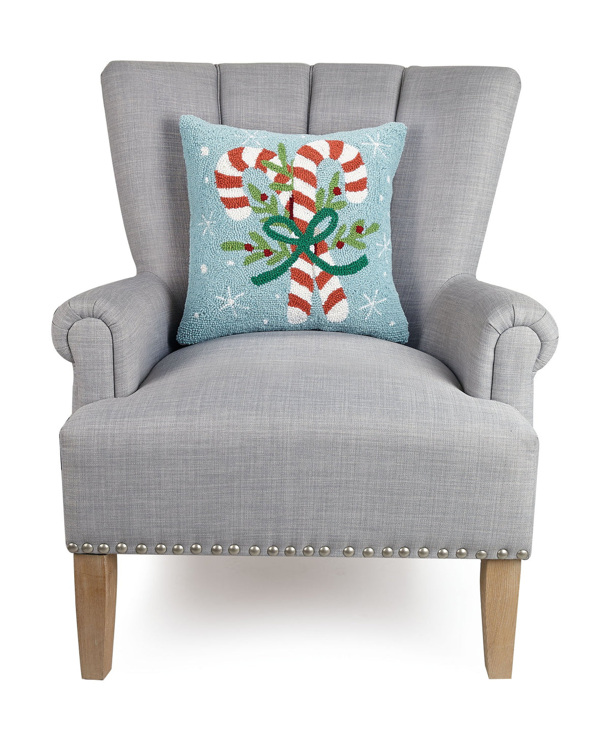 Candy Canes Hooked Wool Christmas Throw Pillow on an armchair, showing the throw pillow at room scale, 16x16 inch