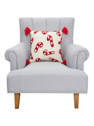 Candy Canes with Tassels Hooked Christmas Throw Pillow on an armchair, showing the throw pillow at room scale, 16x16 inch