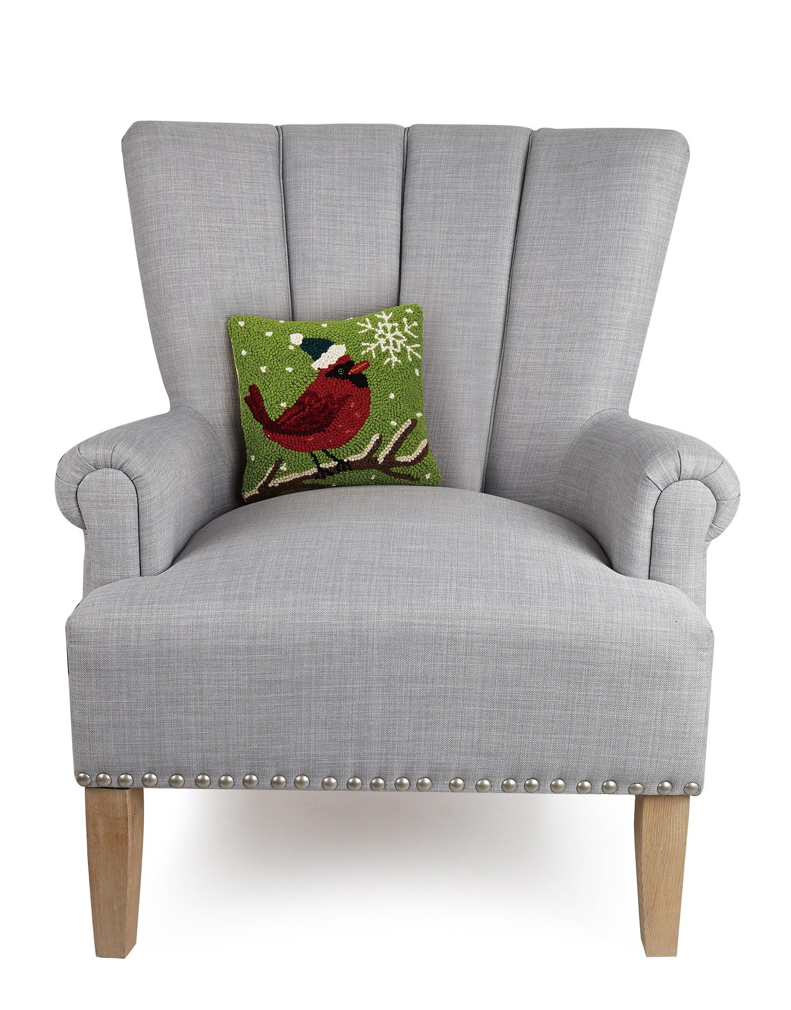 Cardinal with Snowflake Hooked Wool Christmas Throw Pillow on an armchair, showing the throw pillow at room scale, 10x10 inch