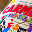 Carmel, CA Coastal City Embroidered Travel Pillow - close-up detail of hand-embroidered needlepoint stitching