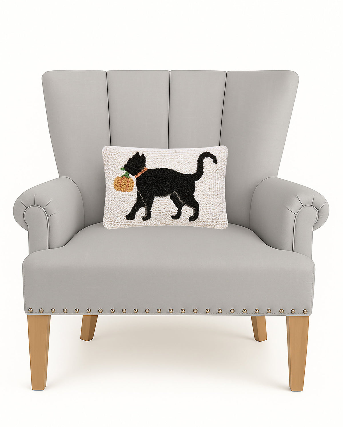 Cat with Pumpkin Hooked Wool Fall Harvest Throw Pillow on an armchair, showing the throw pillow at room scale, 8x12 inch