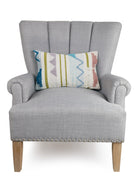 Cayden Decorative Woven Throw Pillow on an armchair, showing the throw pillow at room scale, 12x18 inch