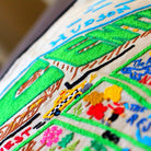 Central Park, NY Scenic Embroidered Travel Pillow - close-up detail of hand-embroidered needlepoint stitching