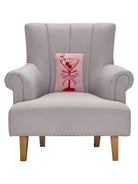 Cherry Martini Hooked Wool Throw Pillow on an armchair, showing the throw pillow at room scale, 8x12 inch