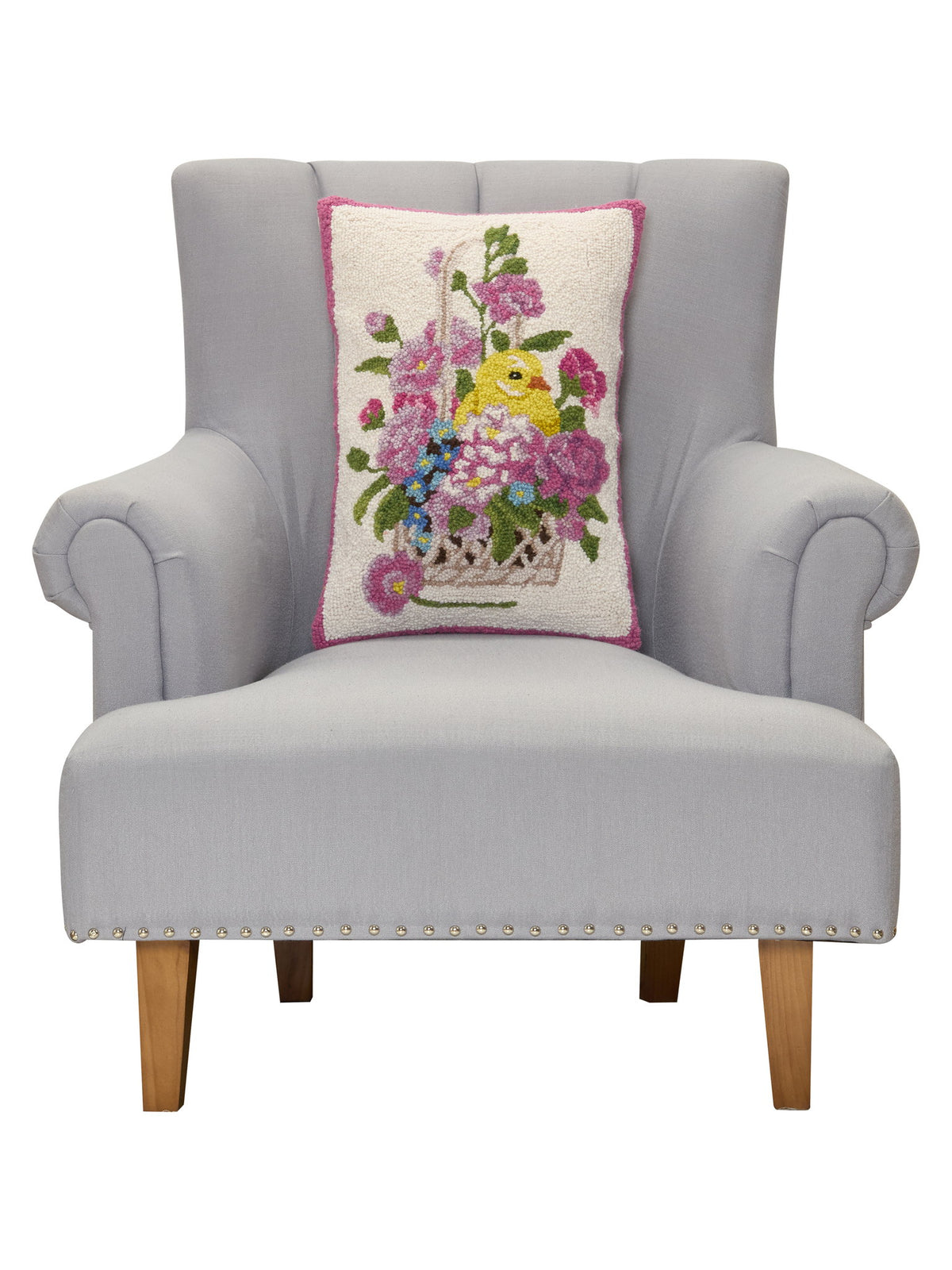Chick Hooked Wool Easter Throw Pillow, 14x20 inch, on a gray armchair, closer view of the chair