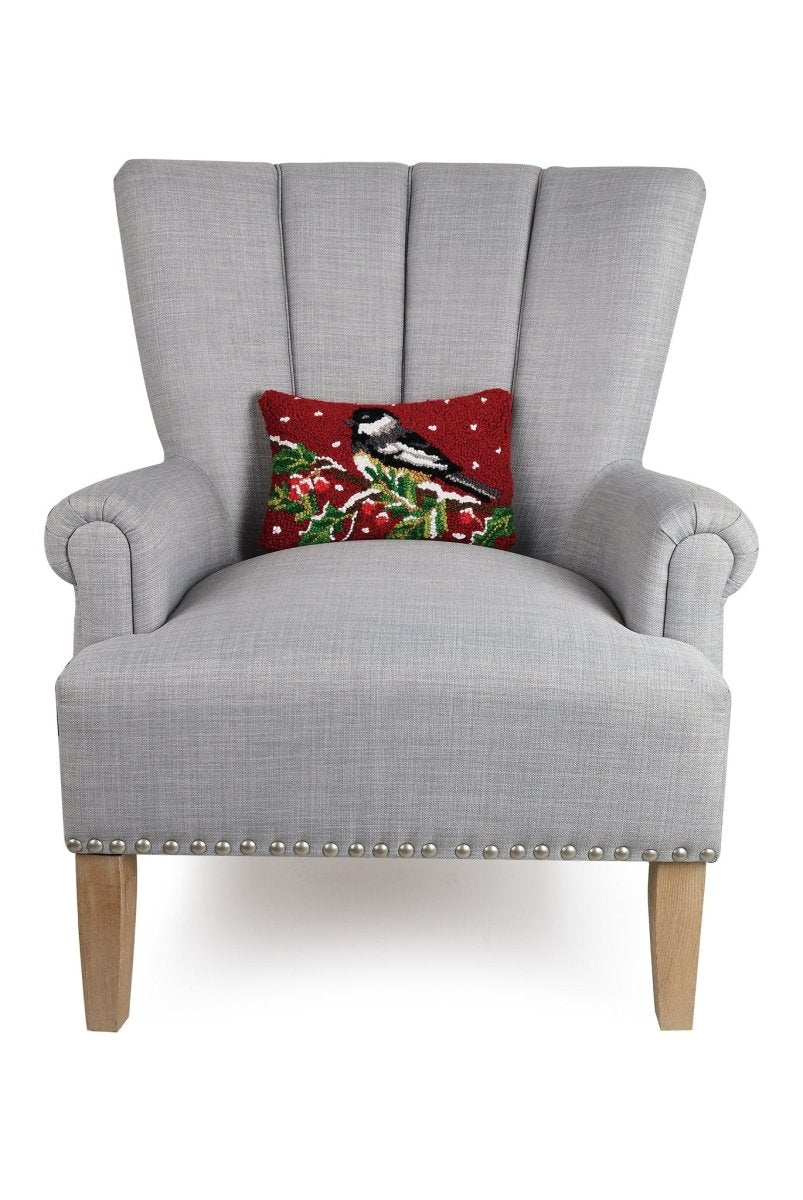 Chickadee on Branch Hooked Wool Christmas Throw Pillow on an armchair, showing the throw pillow at room scale, 8x12 inch