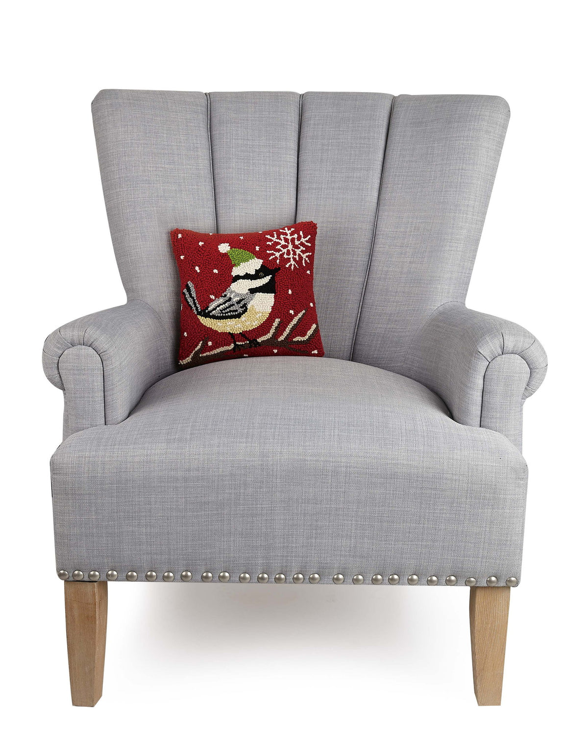 Chickadee with Snowflake Hooked Wool Christmas Throw Pillow on an armchair, showing the throw pillow at room scale, 10x10 inch