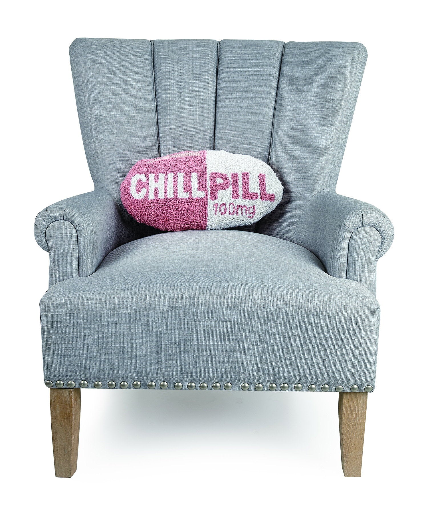 Chill Pill Hot Pink Hooked Wool Throw Pillow on an armchair, showing the throw pillow at room scale, 9x16 inch