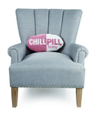 Chill Pill Hot Pink Hooked Wool Throw Pillow on an armchair, showing the throw pillow at room scale, 9x16 inch