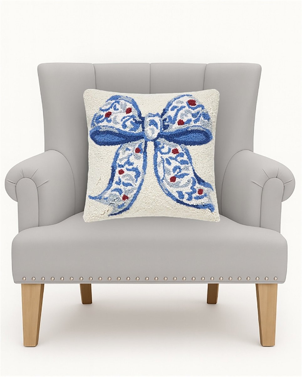 Chinoiserie Bow Hooked Wool Christmas Throw Pillow on an armchair, showing the throw pillow at room scale, 16x16 inch