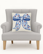 Chinoiserie Bow Hooked Wool Christmas Throw Pillow on an armchair, showing the throw pillow at room scale, 16x16 inch