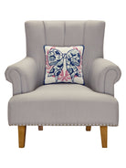 Chinoiserie Bow Hooked Wool Throw Pillow on an armchair, showing the throw pillow at room scale, 14x14 inch
