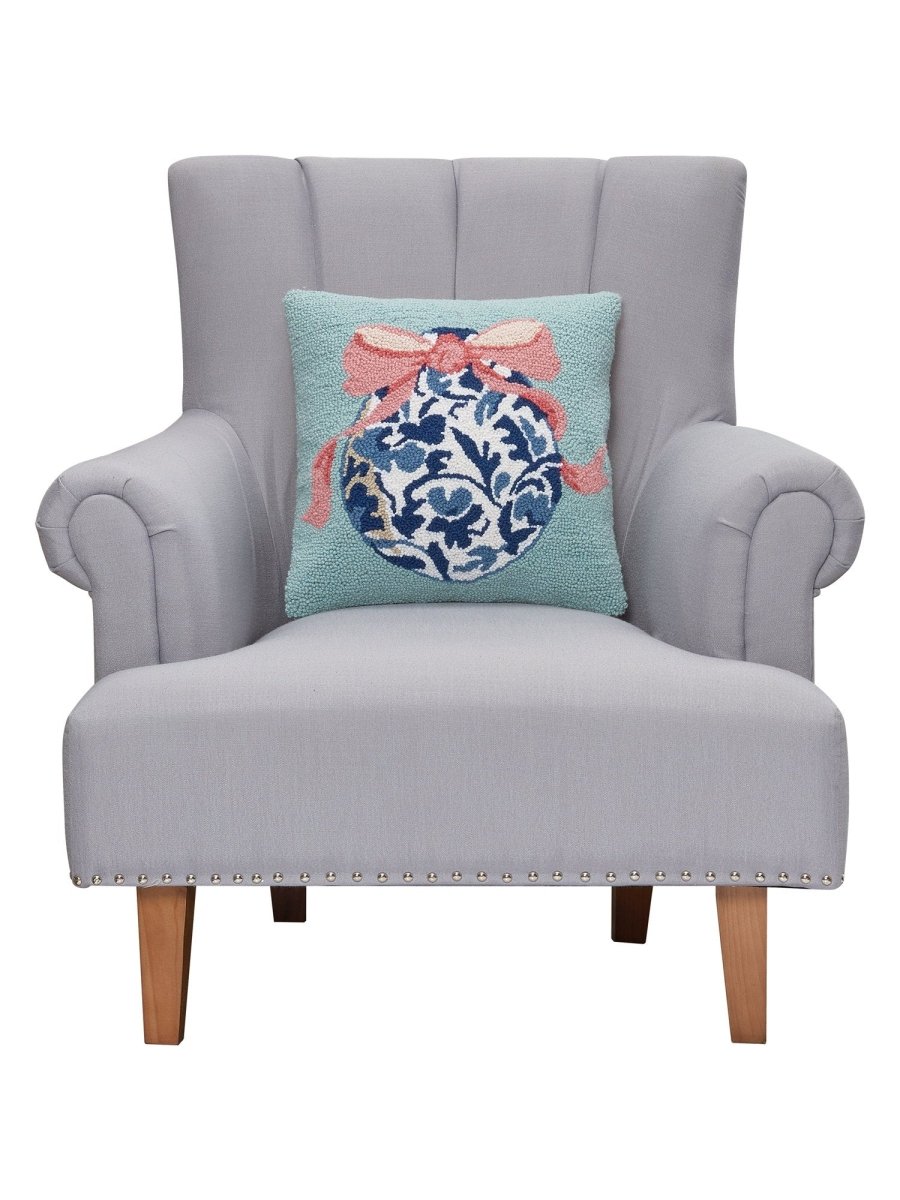 Chinoiserie Easter Egg Hooked Wool Throw Pillow on an armchair, showing the throw pillow at room scale, 16x16 inch