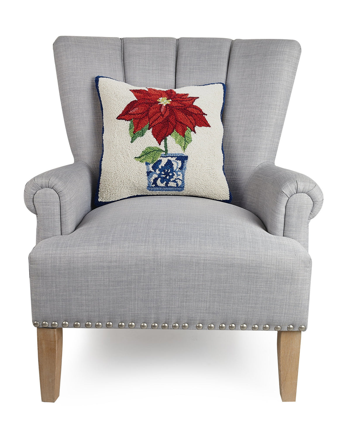 Chinoiserie Poinsettia Hooked Wool Christmas Throw Pillow on an armchair, showing the throw pillow at room scale, 16x16 inch