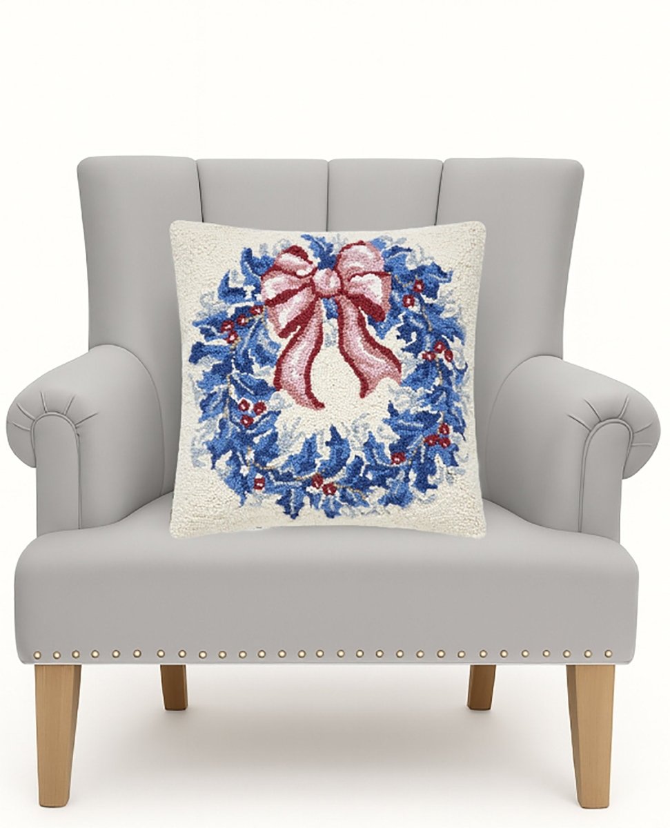 Chinoiserie Wreath Hooked Wool Christmas Throw Pillow on an armchair, showing the throw pillow at room scale, 18x18 inch