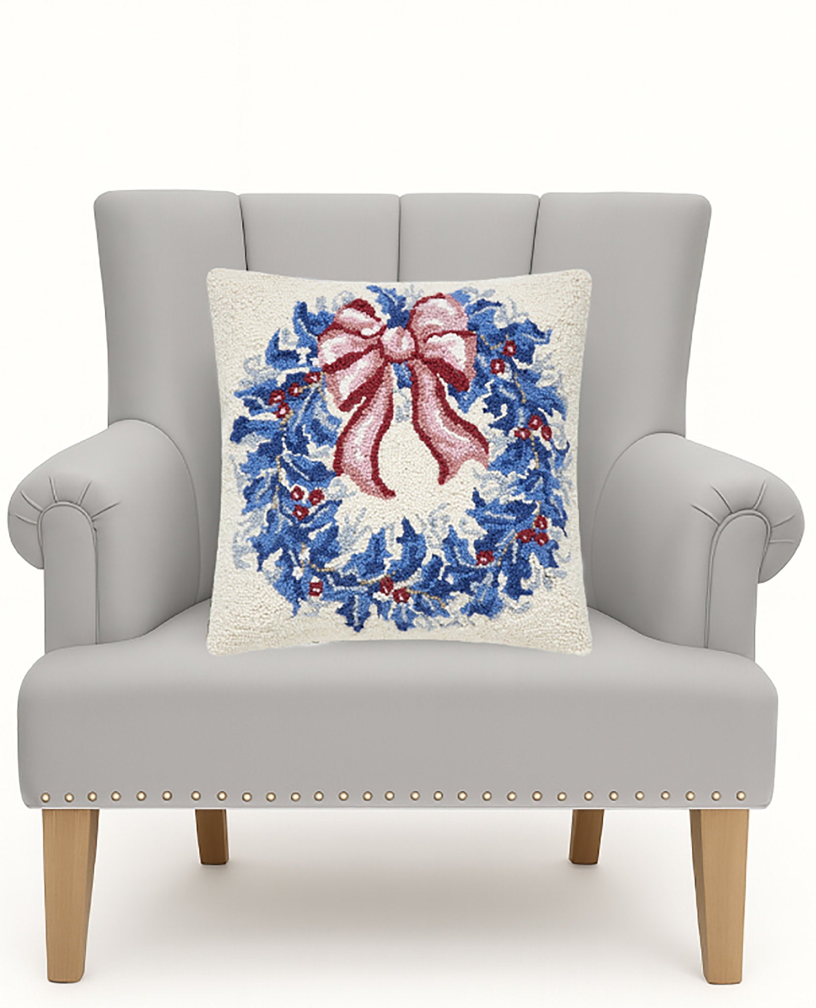Chinoiserie Wreath Hooked Wool Christmas Throw Pillow on an armchair, showing the throw pillow at room scale, 18x18 inch