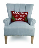 Christmas at the Ranch Hooked Wool Throw Pillow on an armchair, showing the throw pillow at room scale, 12x18 inch