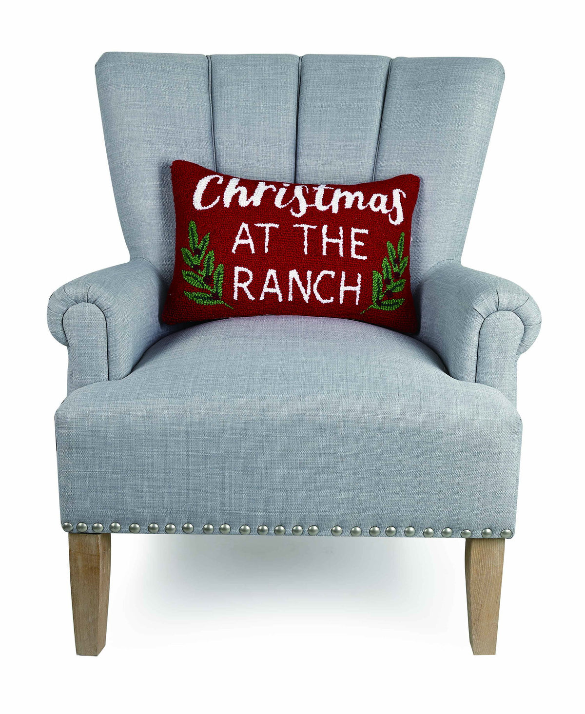 Christmas at the Ranch Hooked Wool Throw Pillow on an armchair, showing the throw pillow at room scale, 12x18 inch