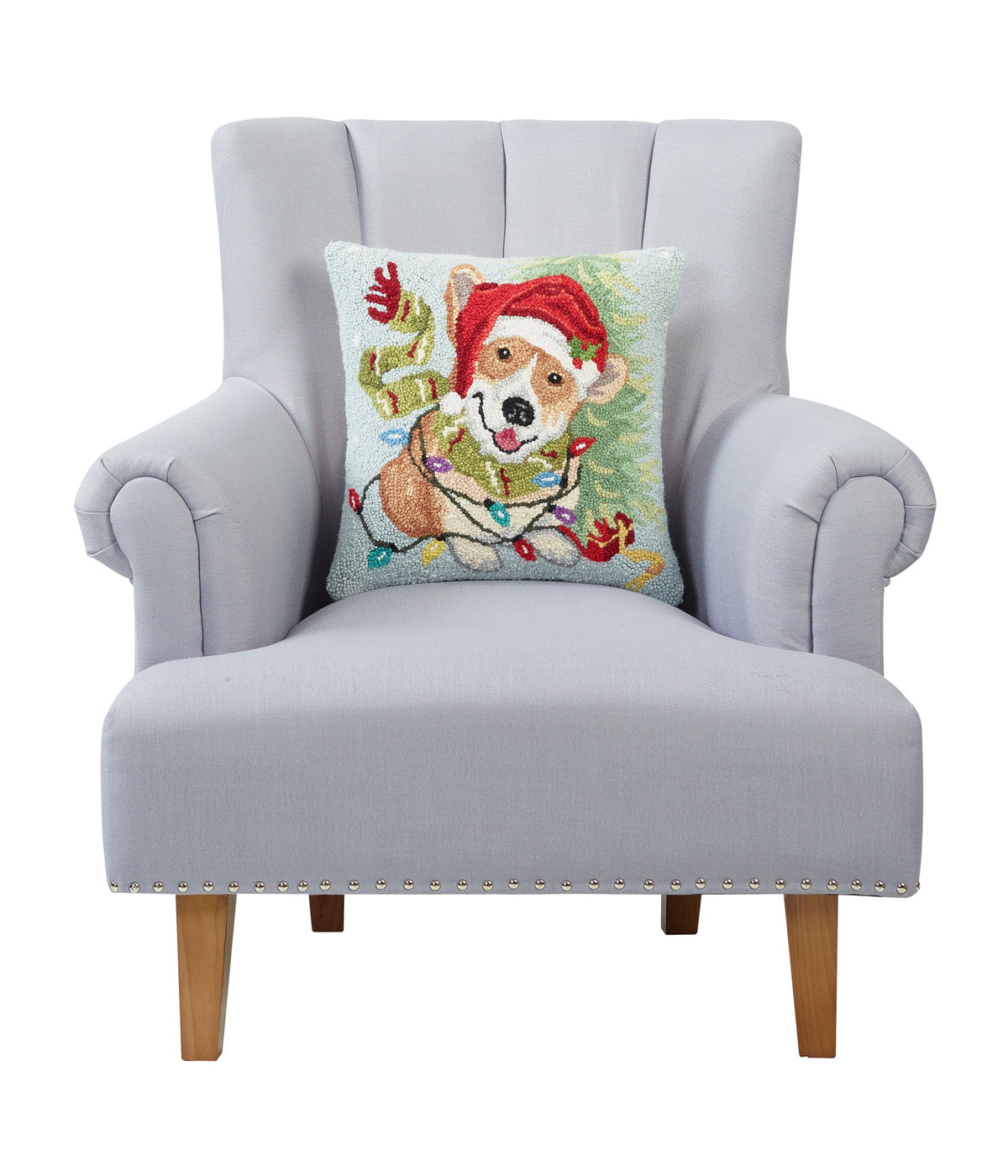 Christmas Corgi Hooked Wool Throw Pillow on an armchair, showing the throw pillow at room scale, 16x16 inch