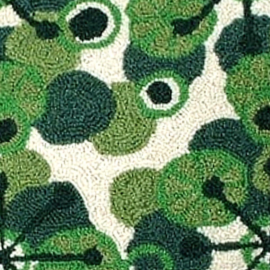 Closeup of Christmas Green Swirl Retro Holiday Wool Hooked needlepoint throw pillow highlighting hand-stitched wool craftsmanship and fabric detail
