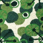 Closeup of Christmas Green Swirl Retro Holiday Wool Hooked needlepoint throw pillow highlighting hand-stitched wool craftsmanship and fabric detail