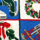 Hand-stitched wool detail of Christmas Ice Skates And Sled needlepoint pillow showing intricate weave pattern and texture