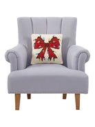 Christmas Lights Bow Hooked Wool Throw Pillow on an armchair, showing the throw pillow at room scale, 14x14 inch